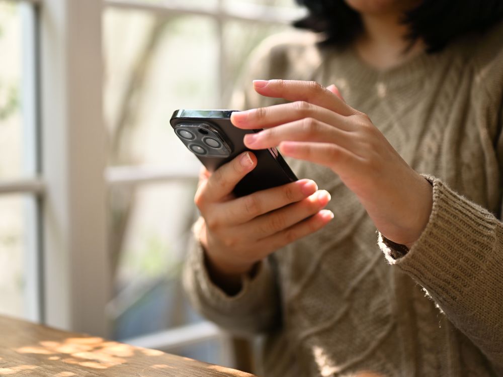 Client viewing an interactive digital travel itinerary on mobile phone Client viewing an interactive digital travel itinerary on mobile phone